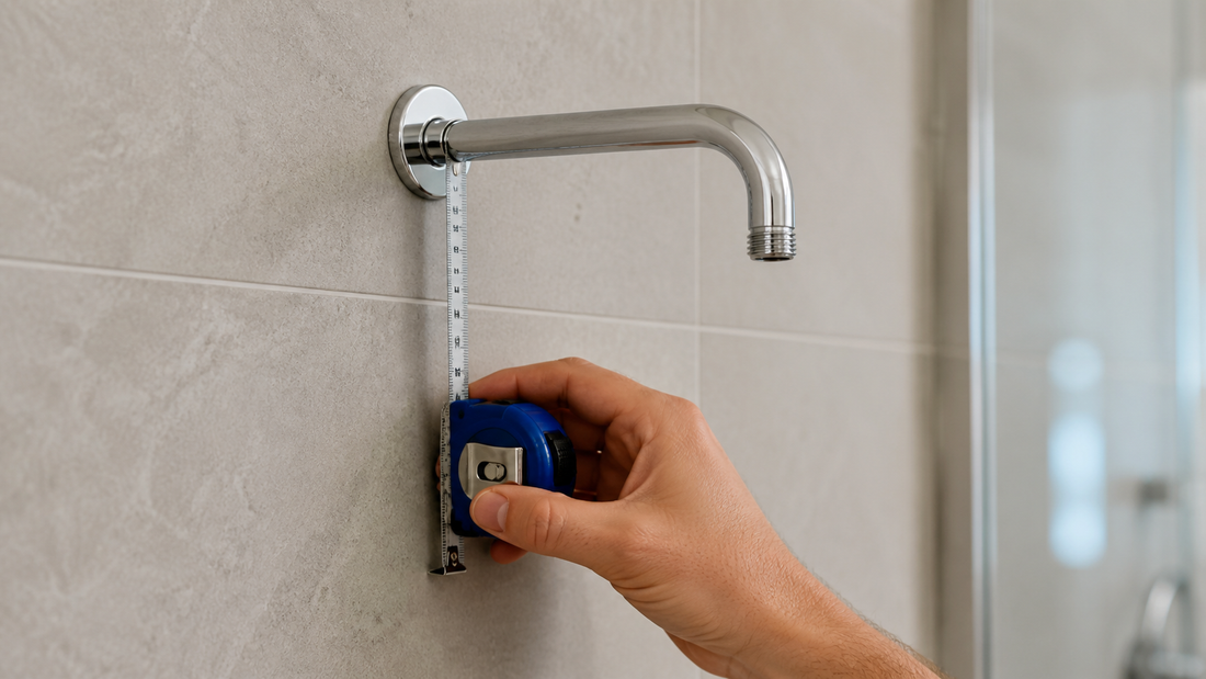 Tape measure checking clearance below an exposed wall-mounted shower arm